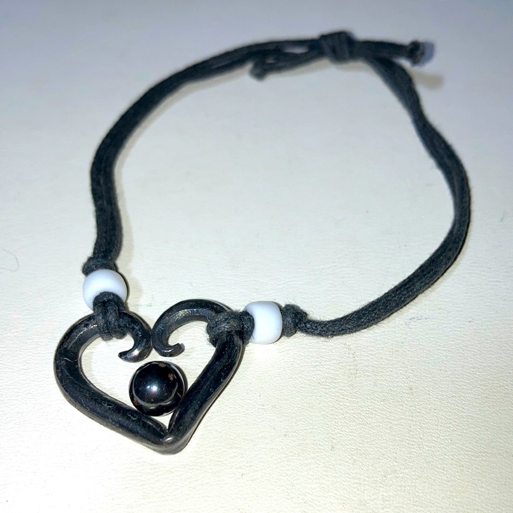 Black twine bracelet w heart and magnetic moveable ball.  Gently used. Bme2732